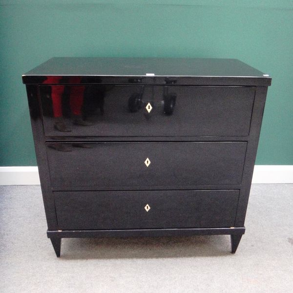 A pair of late 19th century ebonised Continental chests, each with three long drawers, on tapering square supports, 100cm wide.