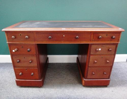 A Victorian mahogany pedestal desk with nine drawers about the knee on plinth base, 120cm wide.