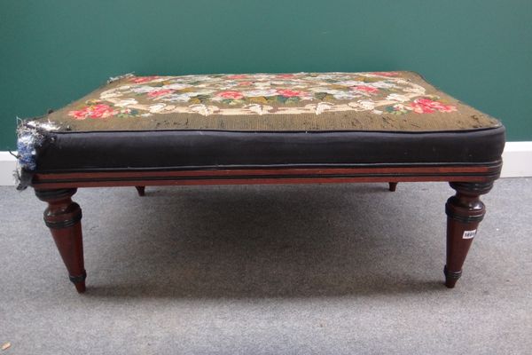 An early 20th century French mahogany framed rectangular footstool on turned tapering supports, 108cm wide.