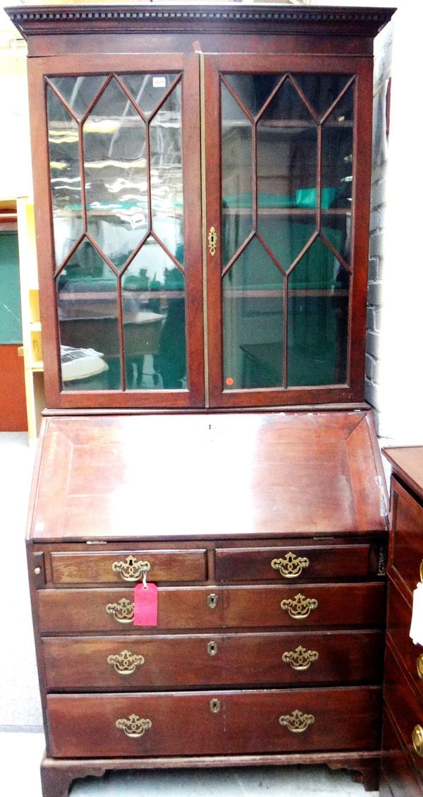 A George III mahogany bureau bookcase, with a pair of astragal glazed doors over a fitted interior, two short and three long graduated drawers on brac