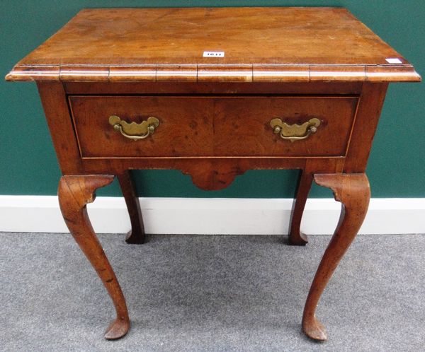 A mid-18th century walnut lowboy, with single frieze drawer, on cabriole supports and pointed pad feet, 61cm wide.