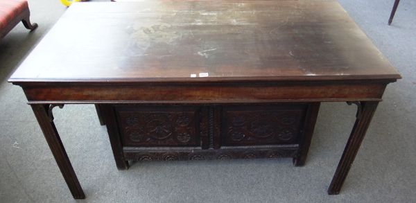 An 18th century mahogany serving table, the rectangular top on four canted square supports, mounted with scroll corner brackets, 146cm wide.