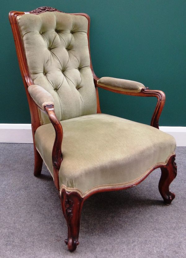 A Victorian walnut framed open armchair with serpentine seat on scroll supports.