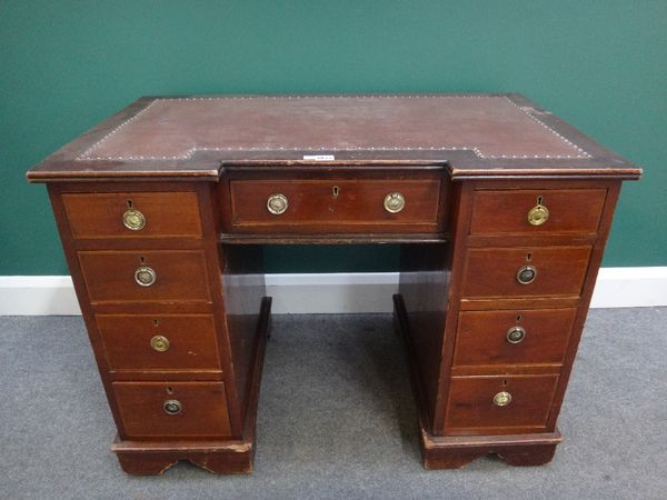 A late 19th century inlaid mahogany inverted breakfront writing desk, with nine drawers about the knee, on shaped plinth base, stamped Davis & Co 255