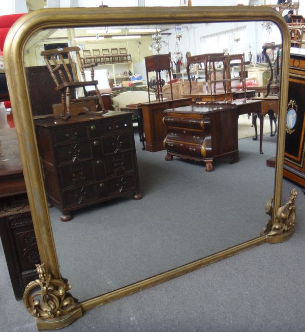 A large Victorian gilt framed rounded rectangular overmantel mirror with carved decoration, 165cm wide x 150cm high.