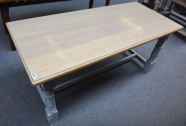 A 20th century oak kitchen table, the bleached plank top on four grey painted turned supports united by H-frame stretcher, 77cm x 168cm wide.