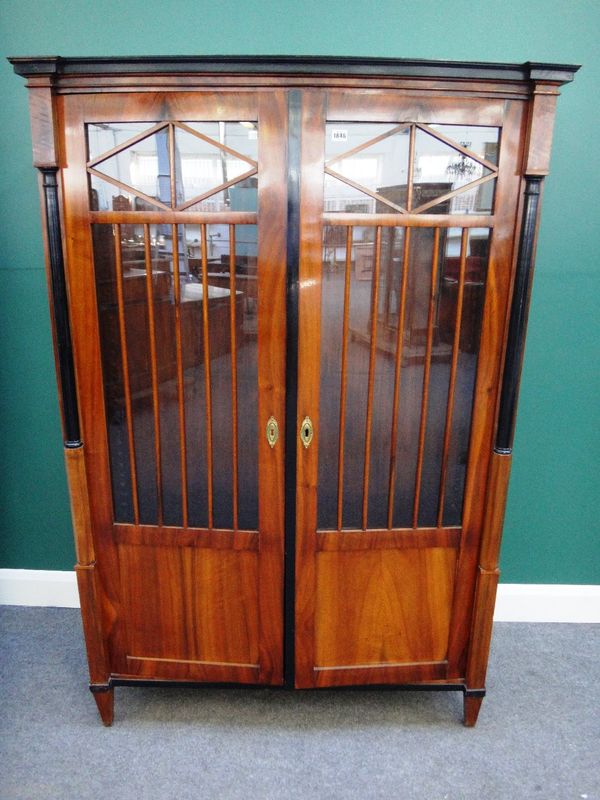 A 19th century Russian walnut Biedermeier two door display cabinet, with split turned ebonised columns, 115cm wide x 171cm high.