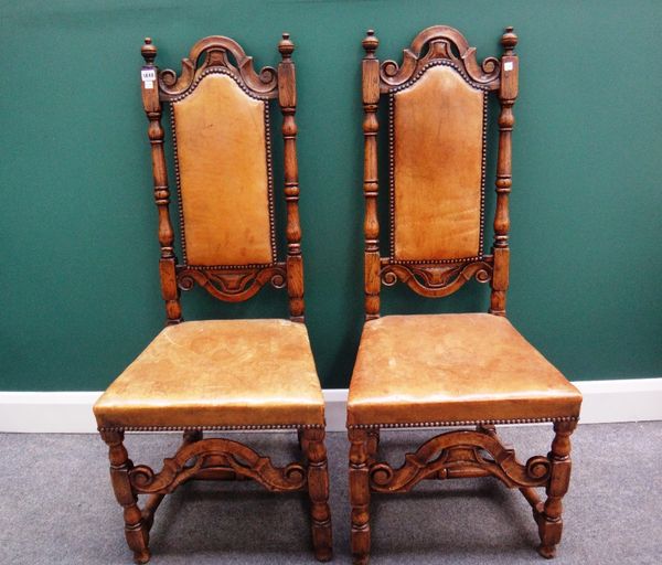 A set of six 17th century style oak framed high back dining chairs, with turned supports and carved and shaped front stretcher.