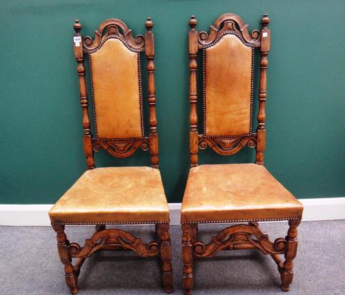 A set of six 17th century style oak framed high back dining chairs, with turned supports and carved and shaped front stretcher.
