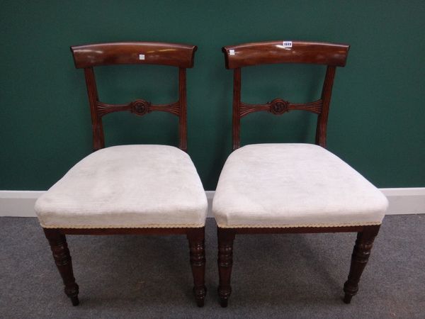 A set of six 19th century mahogany dining chairs with concave crest and carved bullseye waist rail on turned supports.