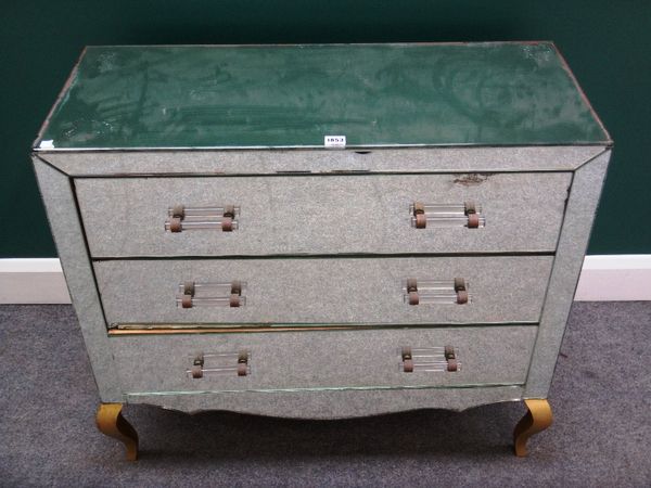 A 20th century mirror veneered chest of three long drawers on gilt cabriole supports, 89cm wide.