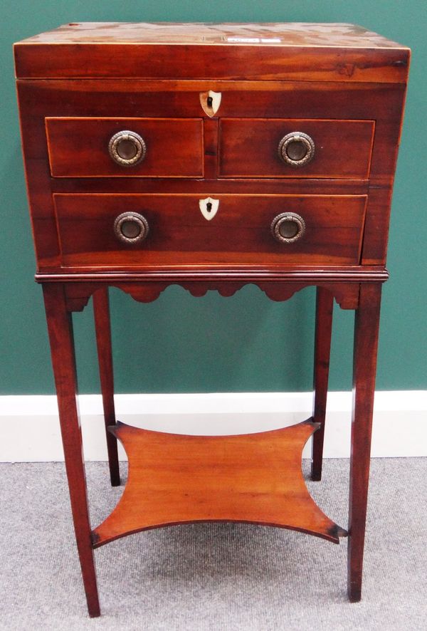 A George III cross banded line inlaid mahogany sewing table, with lift top over two short and one long drawer, on tapering square supports, united by