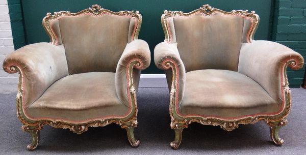 A pair of Louis XV style green, gilt and cream painted easy armchairs on scroll supports.