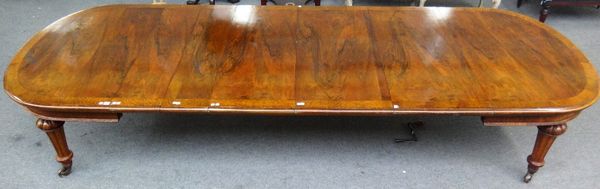 A Victorian oak banded walnut oval extending dining table, on tapering fluted supports, with five extra leaves, 132cm wide x 166cm long, 373cm fully e