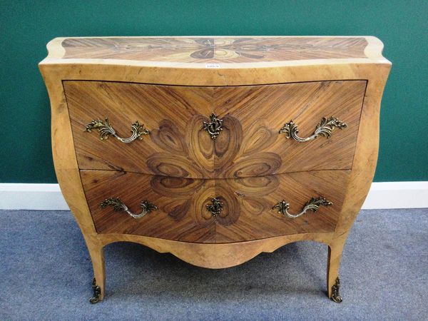 An 18th century style amboyna oyster inlaid gilt metal mounted walnut bombe two drawer commode on splayed supports, 107cm wide.