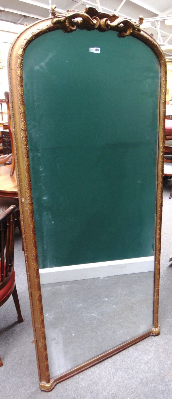 A 19th century gilt framed arch top wall mirror with shell moulded frieze, 90cm wide x 200cm high overall.