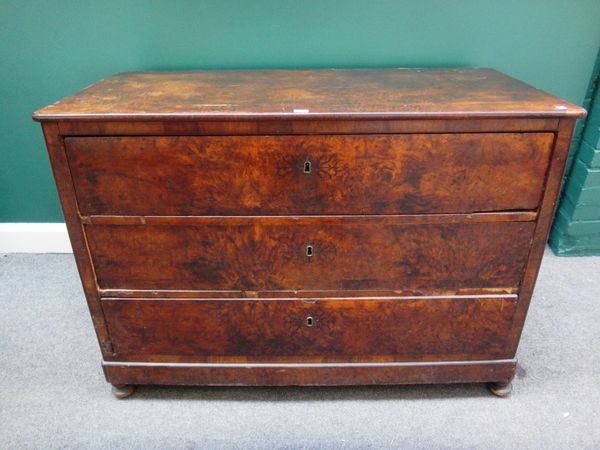 A 19th century French figured walnut commode of three long drawers on bun feet, 124cm wide.