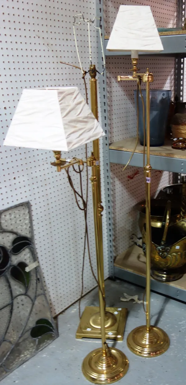A pair of adjustable brass standard lamps and another brass standard lamp. (3)