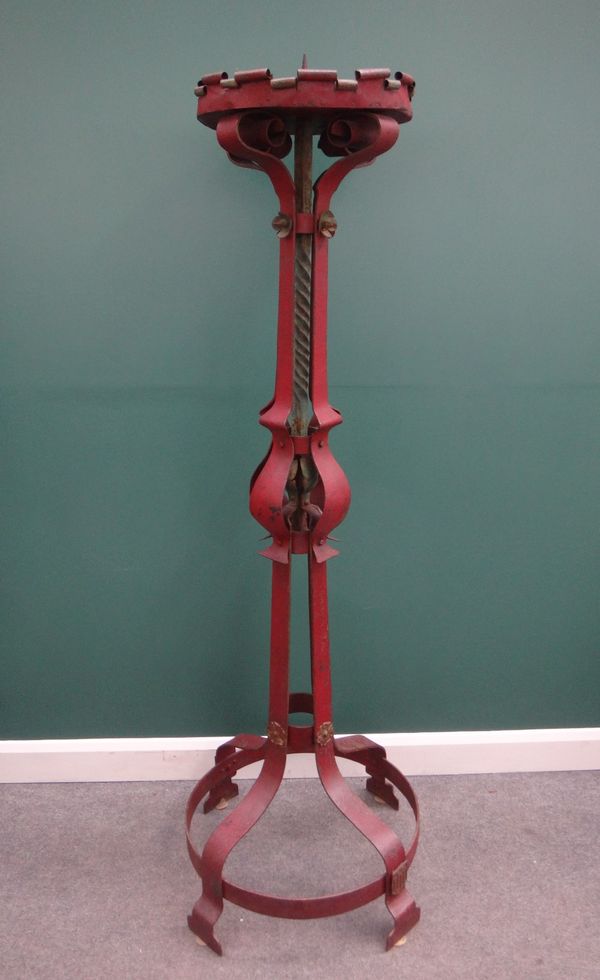 A Gothic Revival red painted wrought iron torchere in the manner of Pugin, on circular base, 188cm high.