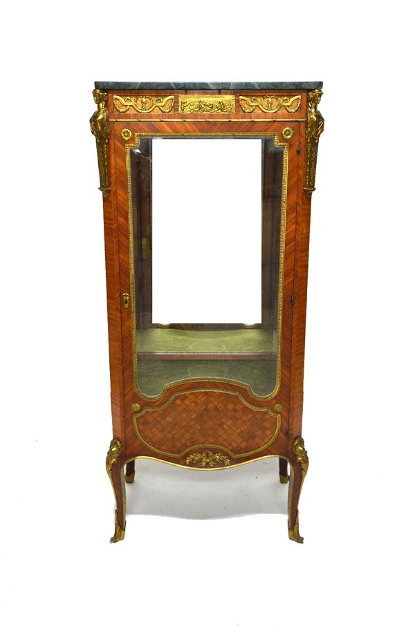 A Louis XVI style vitrine the marble top over a gilt metal mounted parquetry inlaid Kingwood shaped single door base on slender cabriole supports, 67c