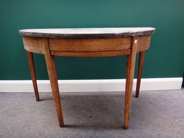 A demi-lune console table with black marble top on a George III stripped oak base with tapering square supports, 116cm wide.