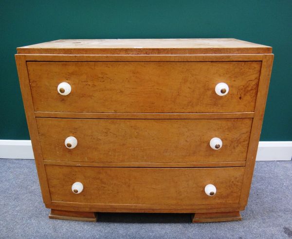 An Art Deco figured walnut bowfront chest with three long drawers, with spherical opaline resin moulded handles, 99cm wide.