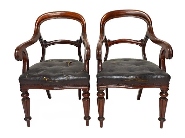 A pair of 19th century mahogany framed open arm carver chairs, with shaped waist rail and serpentine seat, on tapering reeded supports, stamped Gillow