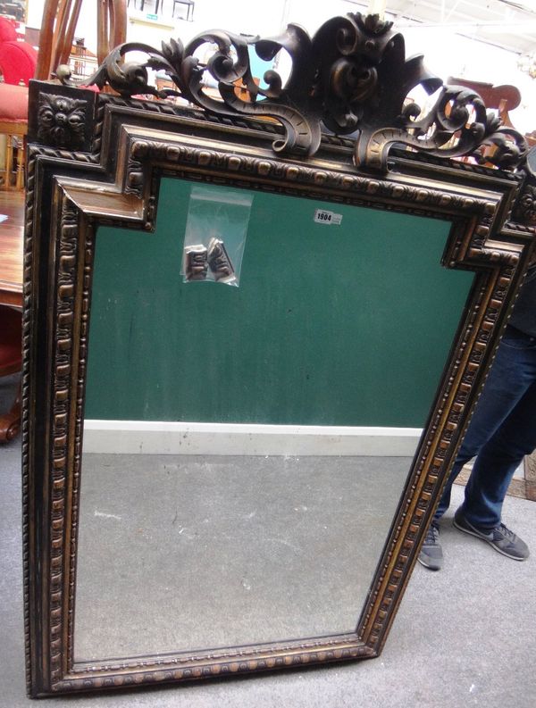 A late 19th century gilt framed wall mirror, with cartouche scroll crest and egg and dart moulded frame, 97cm wide x 153cm high.