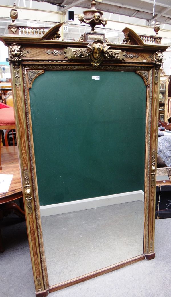 A large late 19th century parcel gilt faux wood painted wall mirror, with urn mounted broken arch crest over shaped bevelled mirror plate, 115cm wide