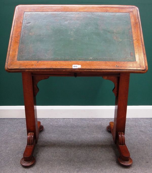 An early 19th century mahogany reading table, the rectangular height and angle adjustable top, on a pair of trestle end standards and compressed bun f