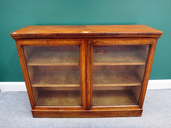 A 19th century walnut glazed two door bookcase, on plinth base, 122cm wide.