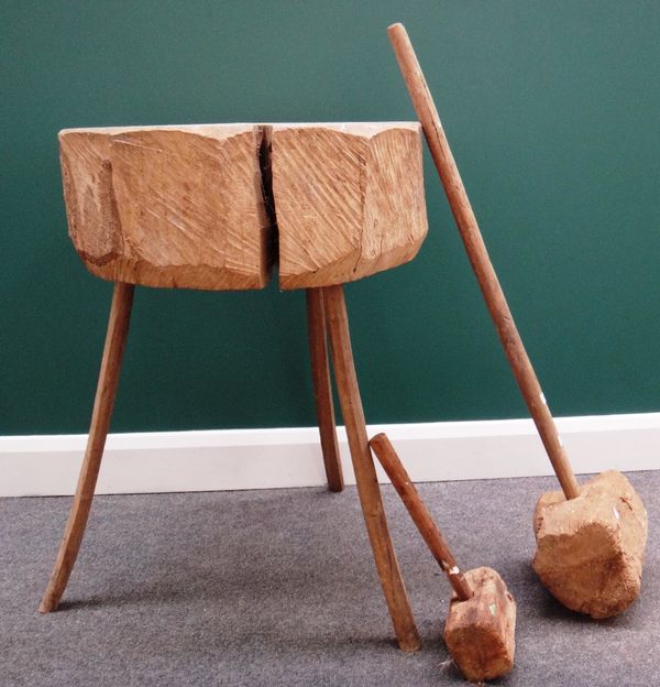 A French Provincial chopping table, the shaped oak top on three staked supports, 60cm wide, together with two wooden mallets.