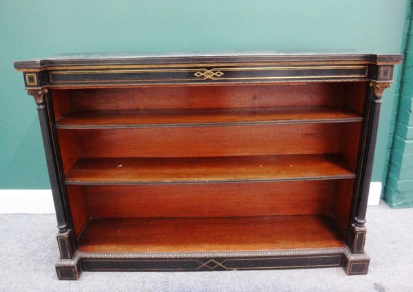 A 19th century gilt metal mounted ebonised floor standing open bookcase, flanked by turned and fluted columns, 133cm wide.