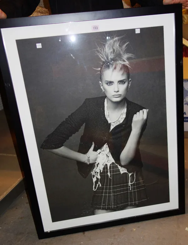 A black and white framed photo of a Chanel model.