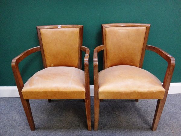 A set of four early 20th century French walnut framed open arm tub chairs on tapering square supports.