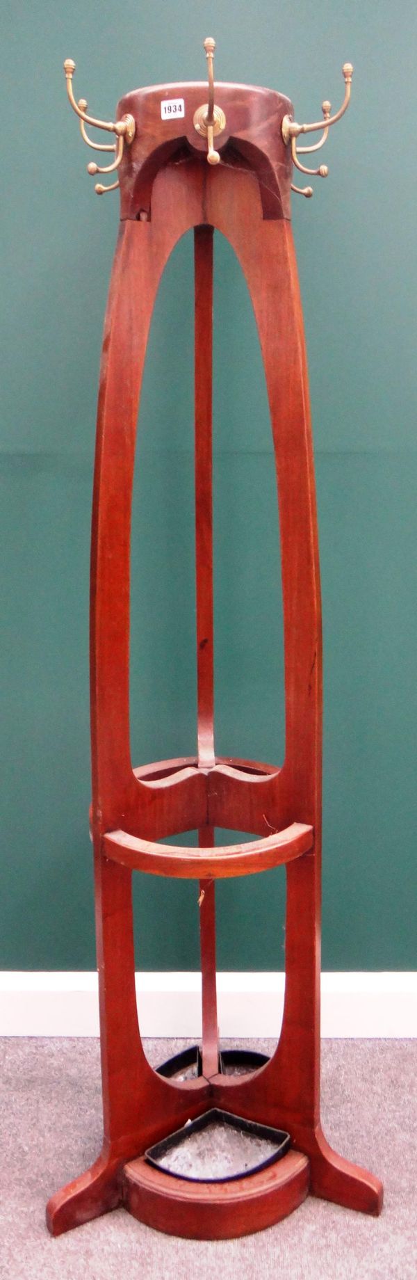 A mid-20th century hardwood coat and umbrella stand, with three open supports and six brass mounted hooks, 175cm high.