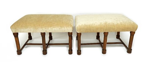 A pair of Gothic revival oak framed stools, each with rectangular overstuffed seats on six octagonal supports, united by chamfered stretchers, each 89