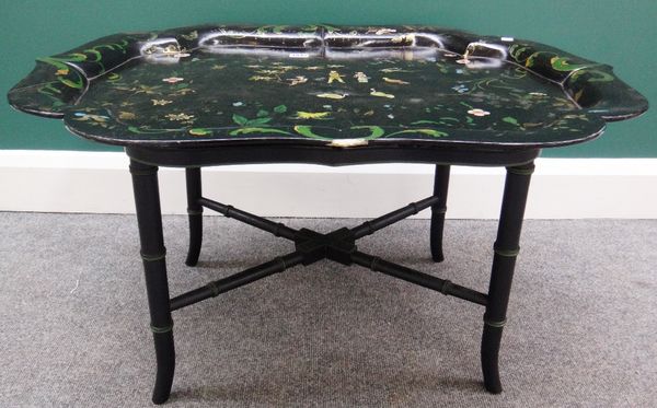 A 19th century chinoiserie decorated black lacquer papier mâché tray on a later faux bamboo stand, 81cm wide.