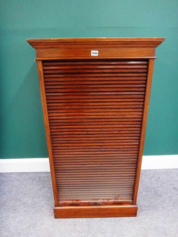 An early 20th century oak and beech filing cabinet, the tambour front revealing sixteen drawers, the escutcheon stamped 'entirely English make H.L.L',