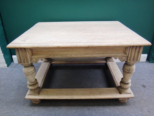 An early 20th century bleached oak rectangular centre table on baluster turned supports, united by a perimeter stretcher, 90cm x 122cm.