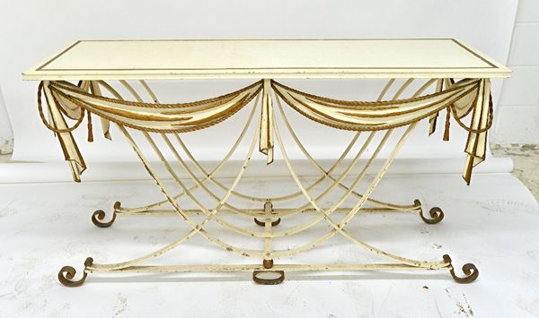 A late 19th century cream painted parcel gilt console table, the rectangular top over a wrought iron open slatted base, with ribbon tied swag frieze,