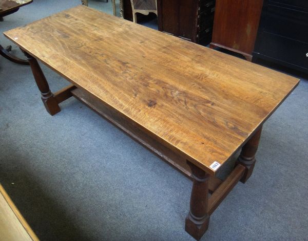 A 17th century style oak refectory table, on four turned supports, united by 'H' stretcher, 68cm wide x 183cm long.