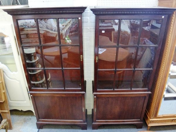 A pair of adapted 18th century mahogany bookcase cupboards, each with dental cornice over single astragal glazed door, on bracket feet, 105cm wide x 2