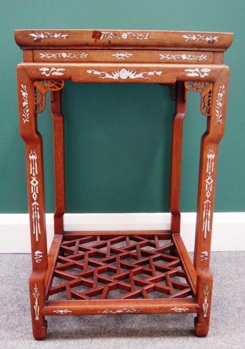 An early 20th century bone inlaid Chinese hardwood urn stand, with secret frieze drawer on four in-stepped square supports, united by a cockpen platfo