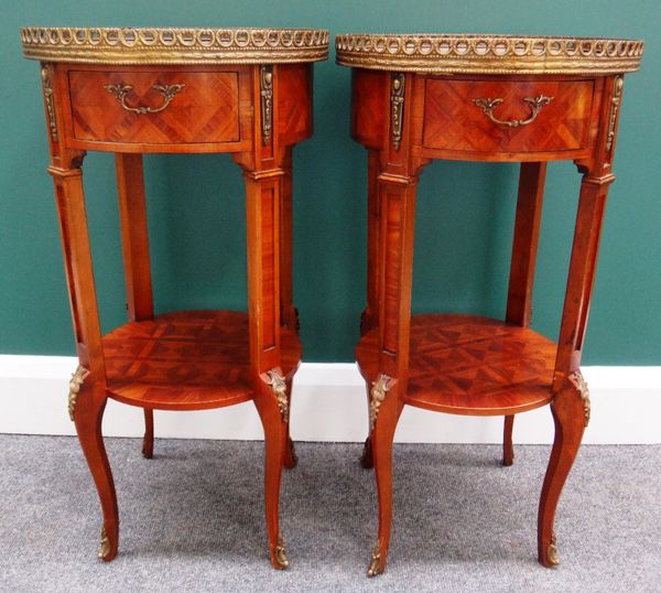 A pair of gilt metal mounted Kingwood circular two tier bedside tables, with single frieze drawer on cabriole supports, 35cm wide.