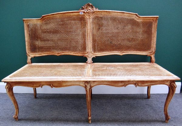 An 18th century style beech show frame sofa with opposing acanthus mounted 'C' scroll crest, over shaped bergère panels and straight front seat on six