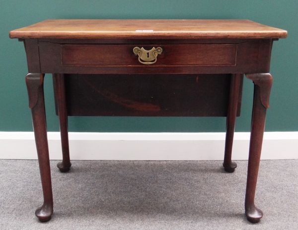 In the manner of Alexander Peter; a mid-18th century mahogany drop-flap side or 'fly' table with single frieze drawer on pad feet, 85cm wide. Note sim