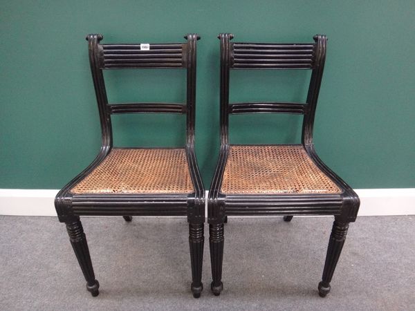 A set of five early 19th century ebonised dining chairs with straight front seat on tapering reeded supports, (5).