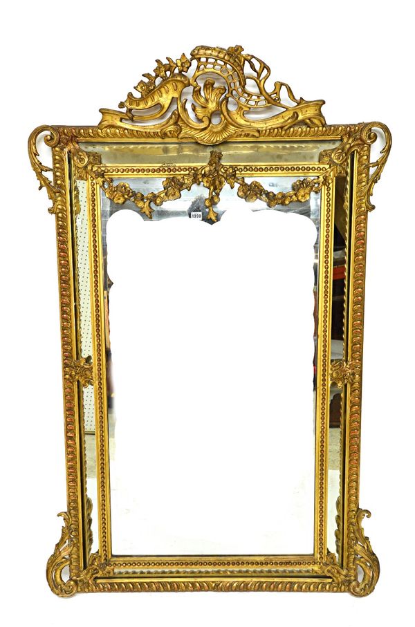 A 19th century gilt framed marginal wall mirror with pierced scroll crest and bevelled mirror plates, 105cm wide x 168cm high.   Illustrated