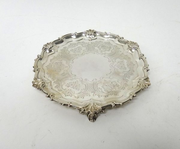 A Victorian silver waiter, of shaped circular form, with a shell and pie-crust rim, otherwise with floral, foliate and scroll engraved decoration and